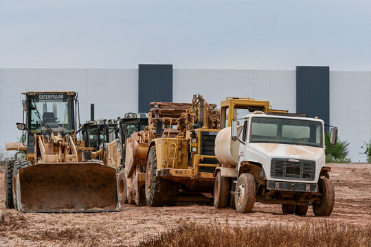 Earthmoving equipment and work truck at a construction site, illustrating land development, site preparation, grading, excavation, and heavy construction operations