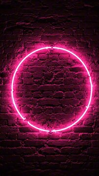 Vibrant pink neon circle glowing against dark textured brick wall for modern design