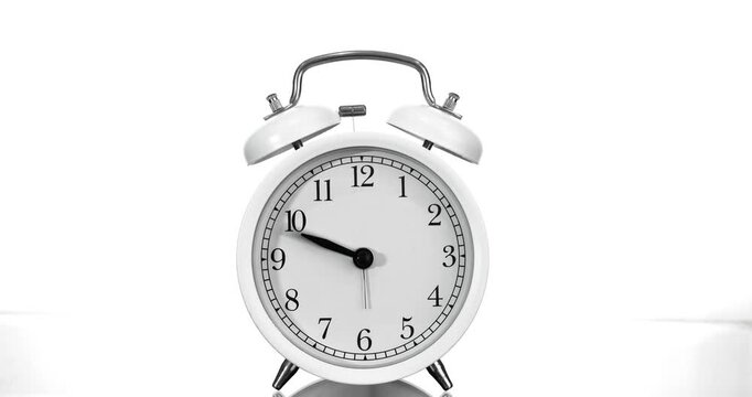 Alarm clock running time lapse on white background
