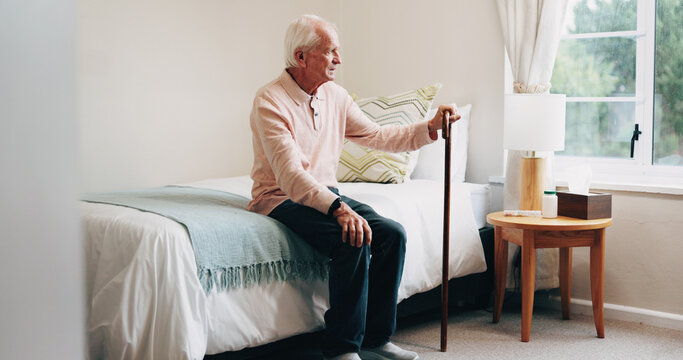 Thinking, relax and senior man in bedroom at house for reflection, remember or retirement memory. Walking stick, nostalgia and elderly person with dementia on bed with ideas for pension in home