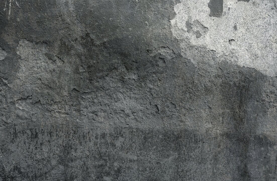 The faded damaged concrete wall background.