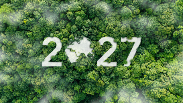 Top view of a green forest with 2027 and earth icon, new year environmental concept for sustainability goals, climate change, happy new year and world environment day.