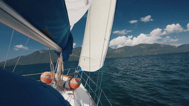 Sailing boat moves under the sails in the fresh sea. Sailing vessel details, no people