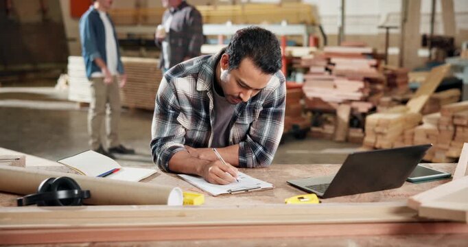 Writing, woodworking and laptop with man in workshop for furniture inventory, research and artisan. Carpenter checklist, quality assurance and clipboard with person in factory for production