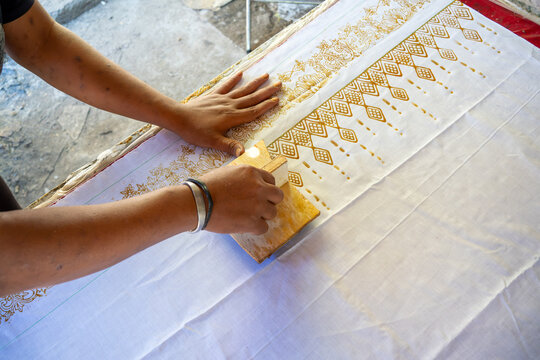 Artisan Hand Printing Traditional Batik Fabric with Wooden Block Tool