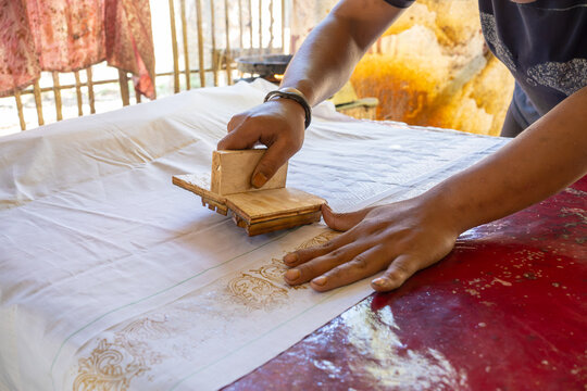 Artisan Creating Traditional Batik Motifs with Hand Stamp Technique