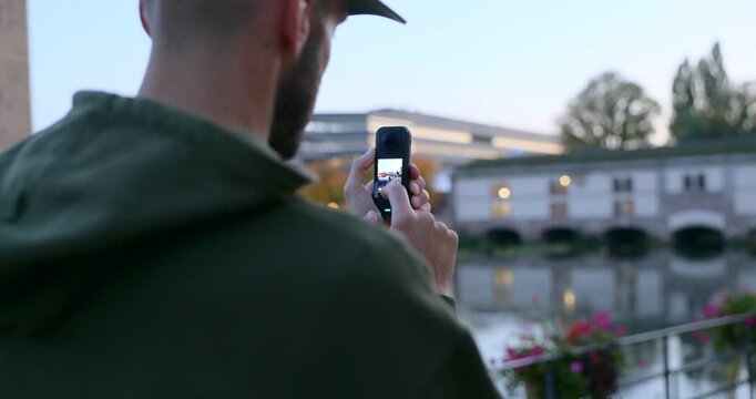 Man using compact Insta360 X4 Air action camera framing view outdoor