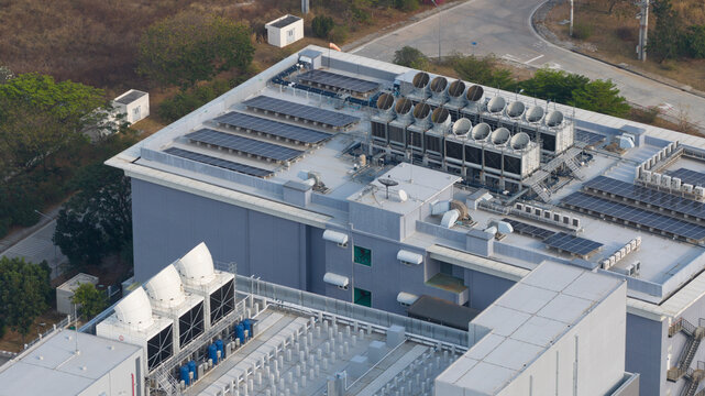 Aerial view of NTT Global Data Centers Thailand Limited featuring rooftop solar panels and industrial cooling towers in Tambon Don Huaro, Chang Wat Chon Buri, Thailand.