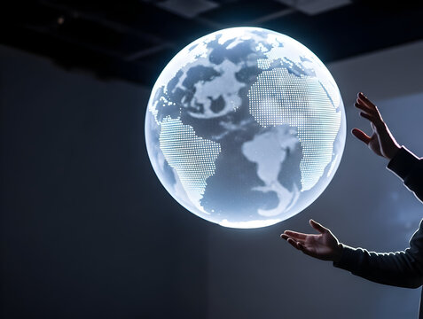 Hands Reaching Towards a Floating 3D Globe Projection Emitting Light in a Modern Interactive Environment