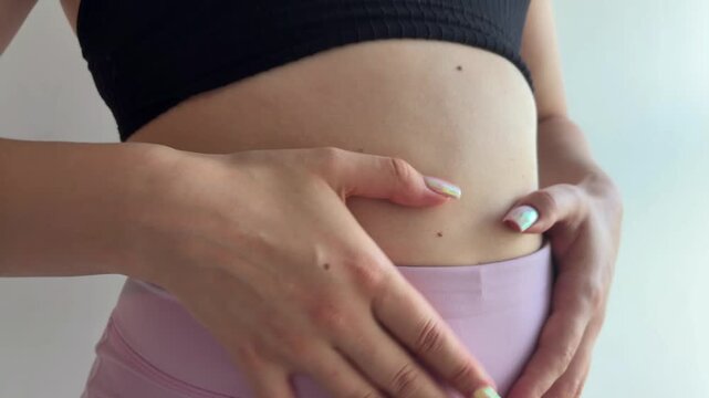 Expectant mother caressing her early pregnancy belly, showcasing maternity and the beautiful journey of motherhood, highlighting the intimate connection with her unborn child