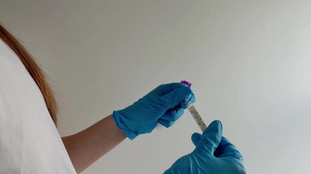 Medical professional wearing blue gloves performing a sterile swab test for a patient's laboratory analysis, ensuring accurate diagnostic results in a clinical setting