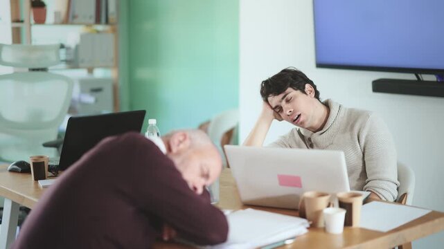 Tired male office workers having nap while sitting in his workplace. High quality 4k footage