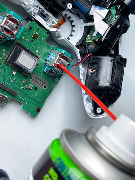 Cleaning and repairing game controller joystick, gaming maintenance and electronics repair concept