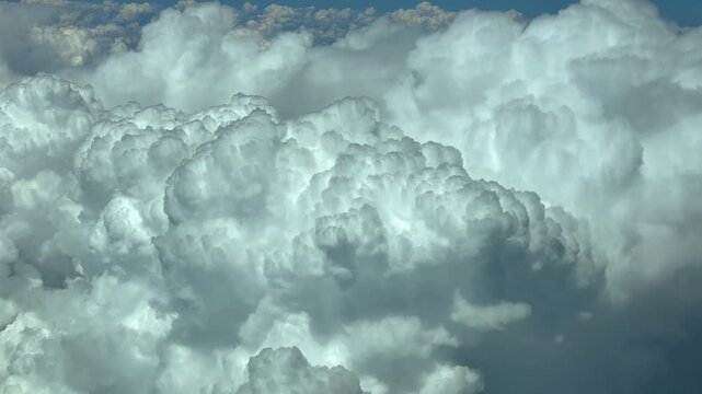Aerial cockpit view of imposing and threatening cumulonimbus storm clouds evolving in the upper atmosphere. Scene taken from a.jet cockpit flying at 10000m high.