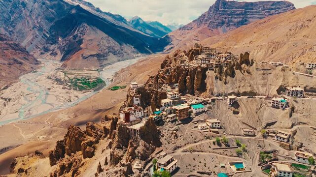 Cinematic aerial drone footage of Dhankar Monastery, an ancient Buddhist monastery dramatically perched on a cliff in Spiti Valley, Himachal Pradesh, India.