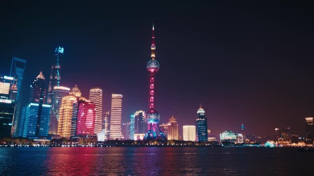 Night shot of the Pudong Lujiazui skyline from The Bund promenade, Shanghai. The Oriental Pearl Tower, Shanghai World Financial Center and Jin Mao Tower are all visible across the Huangpu river.