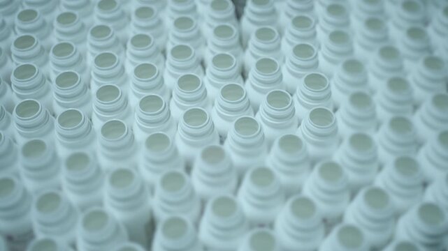 Hundreds of empty medicine containers form a tight grid pattern inside a pharmaceutical hygiene control facility.