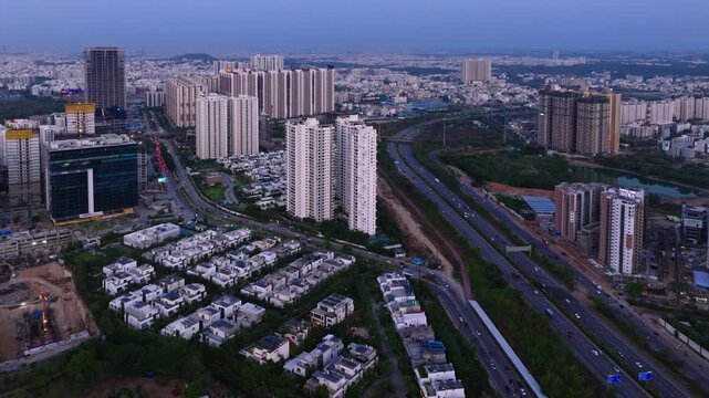 Nehru outer ring road with Jayabheri The Peak, Ramky One Astra and LISA GROVES villas at financial district, kokapet, nanakramguda, hyderabad, telangana, india. day time, static shot, drone shot, 4k.