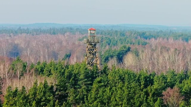 Drone orbits left around Bumbu Hill Firewatch Tower above a peaceful forest