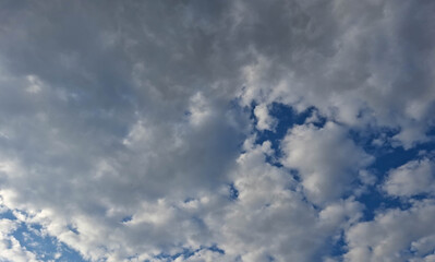 Fototapeta premium Dramatic cloud layers with glimpses of intense blue sky