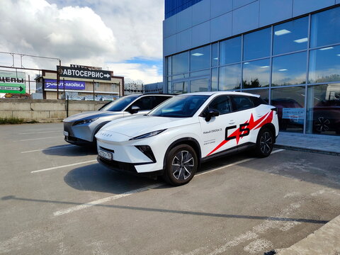 Russia, Samara. June 6, 2026: Jaecoo J6 carson a city street. Omoda is a Chinese automaker. Crisis, no gas. Text in Russian: auto Samara, Alma-Atinskaya Street