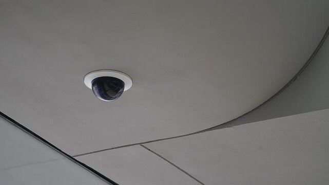 Surveillance camera on building ceiling