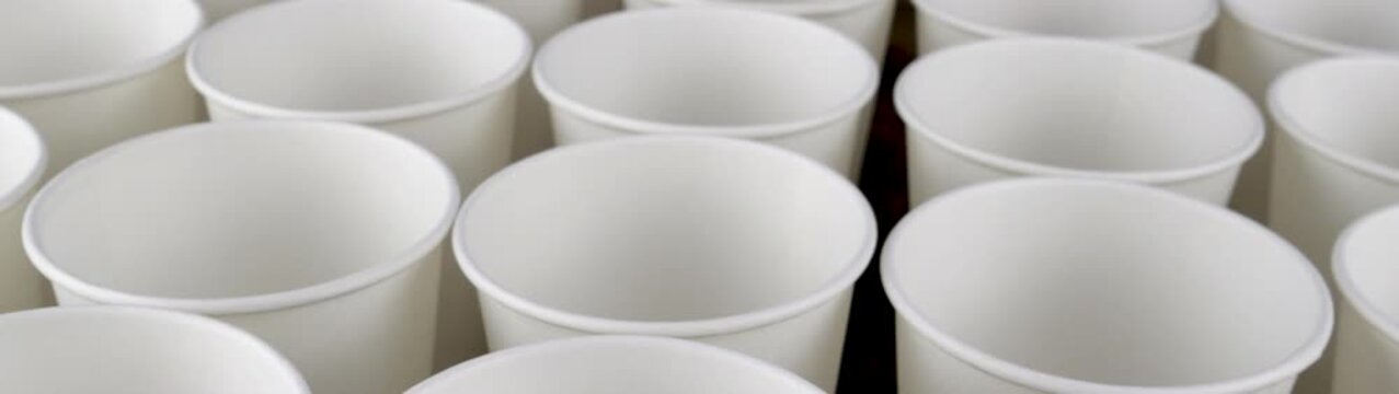 Many small white paper cup arranged closely together Emphasizing repetition and disposability for everyday use.