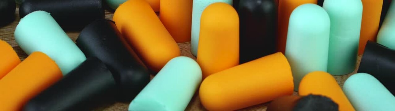 Many earplugs scattered providing protection from unwanted sound and creating silence for sleep or work.