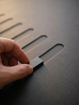 Hand placing matte marker on parallel planning lanes, minimalist business planning and phased growth concept with copy space