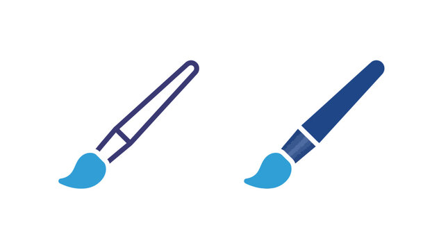 Two paintbrushes with blue tips are lying side by side on a surface.