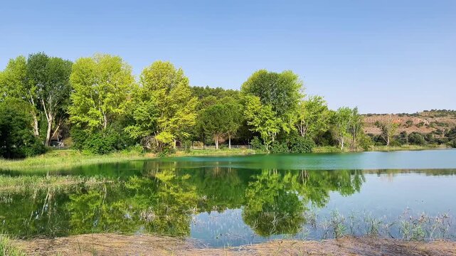 Beautiful landscape of Ruidera lakes with green trees reflection in Spain, natural parc