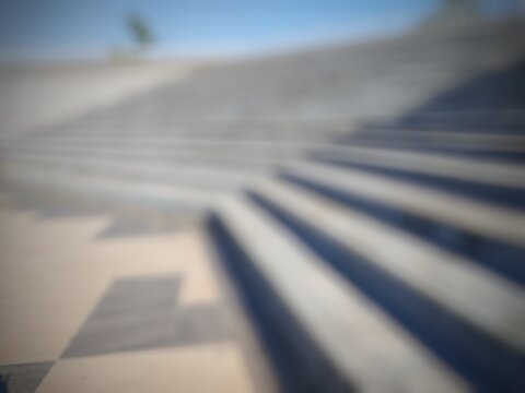 Blurred image of Concrete staircase at Mataram udayana park against the Blue Sky at sunny day 