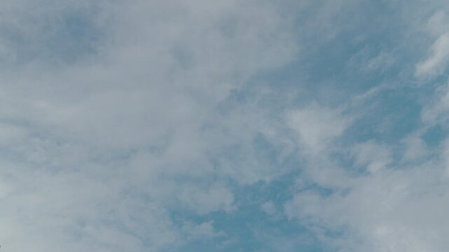 A wide overcast grey sky filled with soft drifting clouds in diffuse daylight, calm and minimal.