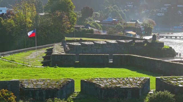 Cinematographic flyover of San Sebastian de la Cruz Castle in Corral, Valdivia, Chile, a row of cannons with a stone structure, colonial architecture