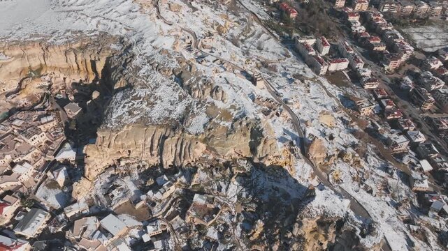 &Uuml;rg&uuml;p, Cappadocia ancient stone houses, Aerial drone flight over snowy rock formations