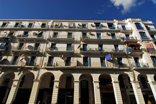 Algeria, Algiers, low angle view of an apartment building with arcade against sky