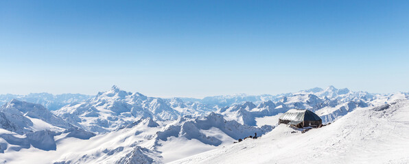 Naklejka premium White snowy winter Caucasus mountains at sunny day. Panorama view from ski slope Elbrus, Russia