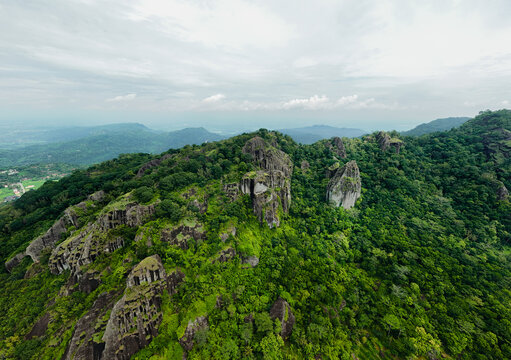 Beautiful drone shot over the green canopy and rugged mountain peaks of Nglanggeran
