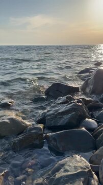 Quiet peaceful sunset landscape over the sea with a rocky shore. Sea, nature, environment