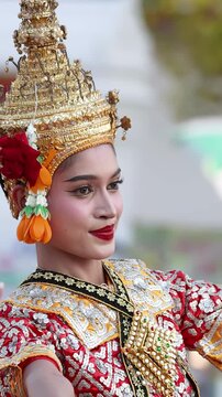Traditional Thai Dancer Performing in Ornate Golden Headdress and Red Costume