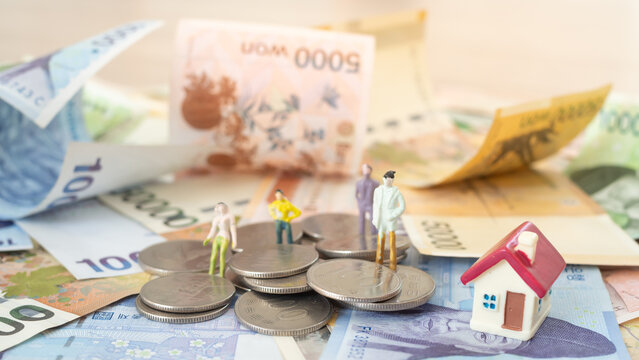 Money investment for house, currency of Korea which is used to represent value in exchange and the won is the main currency of Korean people. Korean won notes for money concept background.