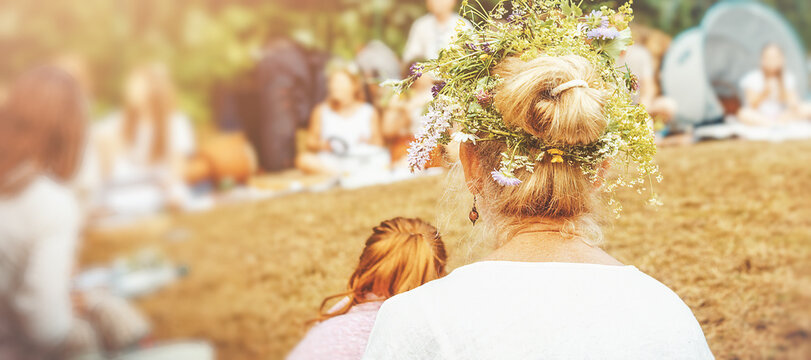 Rear view of woman wearing floral crown during summer solstice.