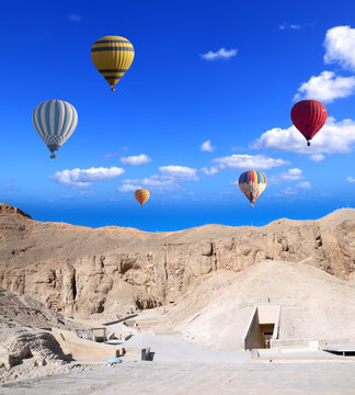 Famous tourist attraction balloon flight in Valley of Kings, Luxor, Egypt. Air balloons over the Theban Necropolis, Luxor, Egypt. Topic of vacation, travel, trip abroad on vacation, cruises and tours