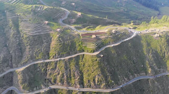 Aerial view of a dangerous high-altitude mountain road leading to a beautiful valley in North India.