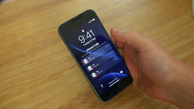 Phone displaying missed calls from a Vet on a lock screen while a person holds the smartphone over a wooden surface in a close-up shot. Mobile notifications emphasize veterinary appointments, pet care