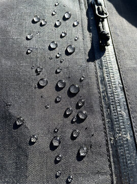 Close-up of vintage fabric with decorative metal studs and intricate embroidery details