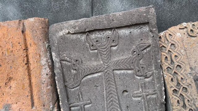 engraved detail of cross Christian religious in church cathedral monastery of Armenian Armenia Yerevan stone tufa masonry facade ornament pattern heritage historic ancient medieval sacred gravestone