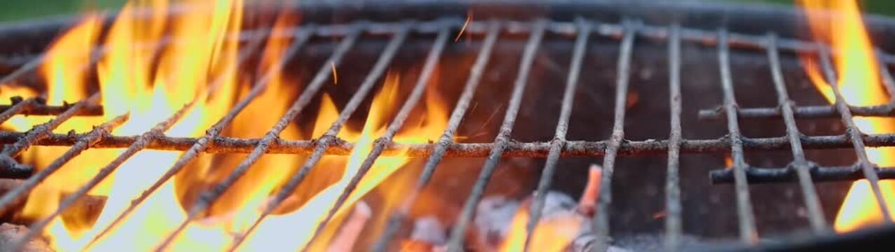Barbecue grill heating up with burning charcoal and glowing embers Preparing for outdoor grilling and a summer cookout.