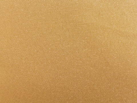 A detailed macro close-up view showing the uniform geometric weave pattern and thread texture of a gold yellow fabric sheet. Target uses for this commercial image include 3D clothing texturing maps