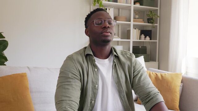Peaceful young african american man breathing deeply